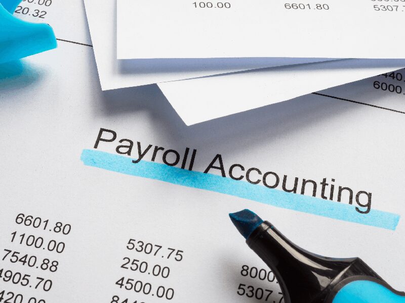 Payroll accounting document with blue highlighter.