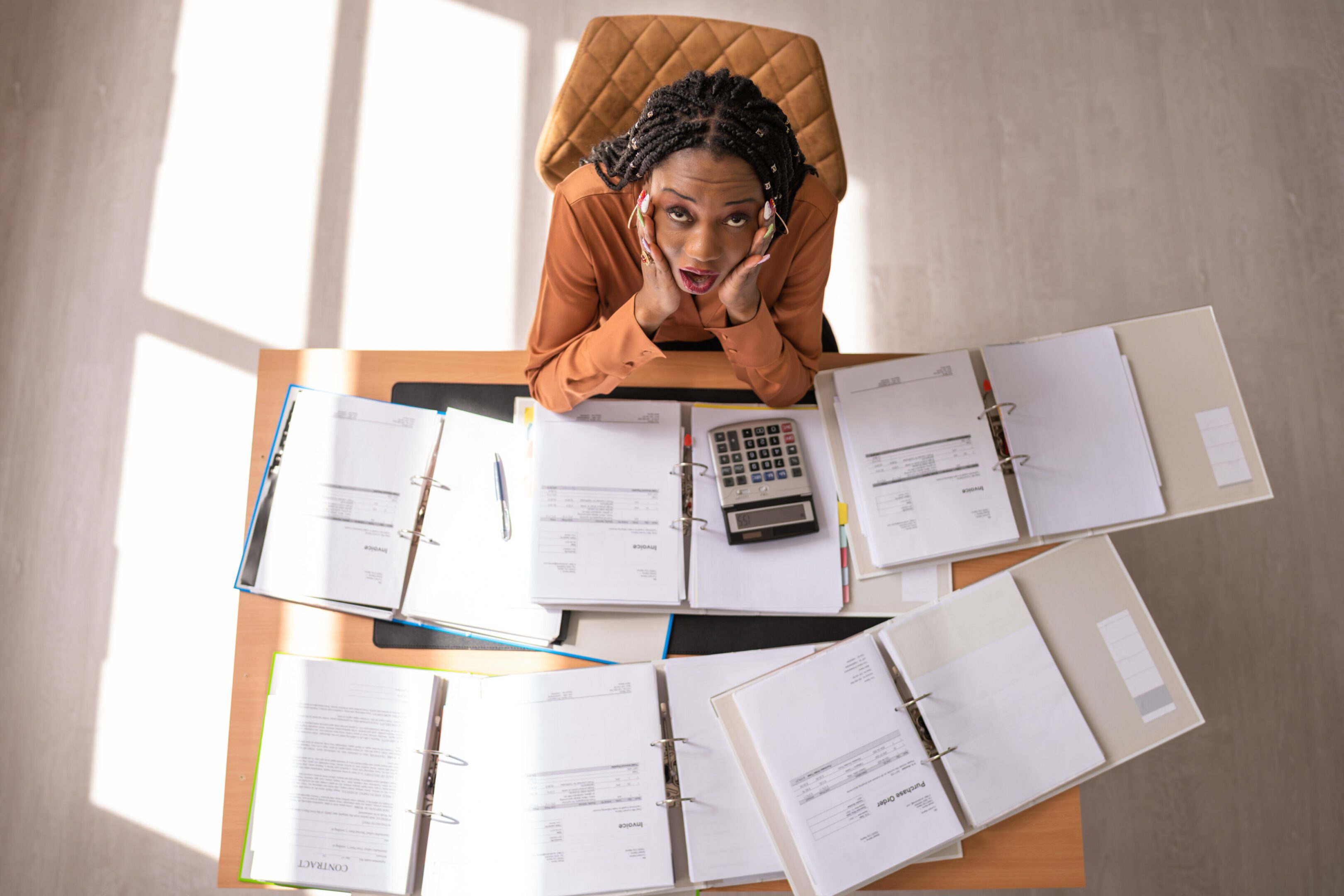 Worried Mature Businesswoman Looking Up With Hands On Cheek