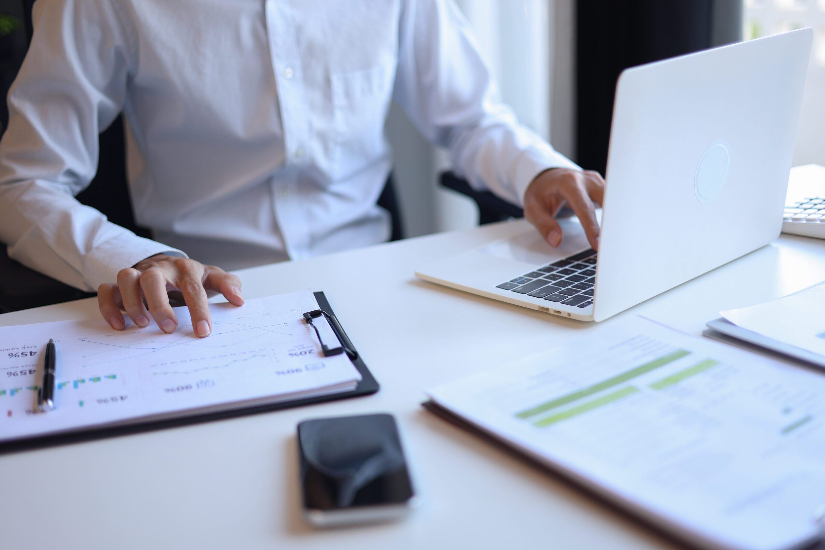 Businessman working in office using laptop.